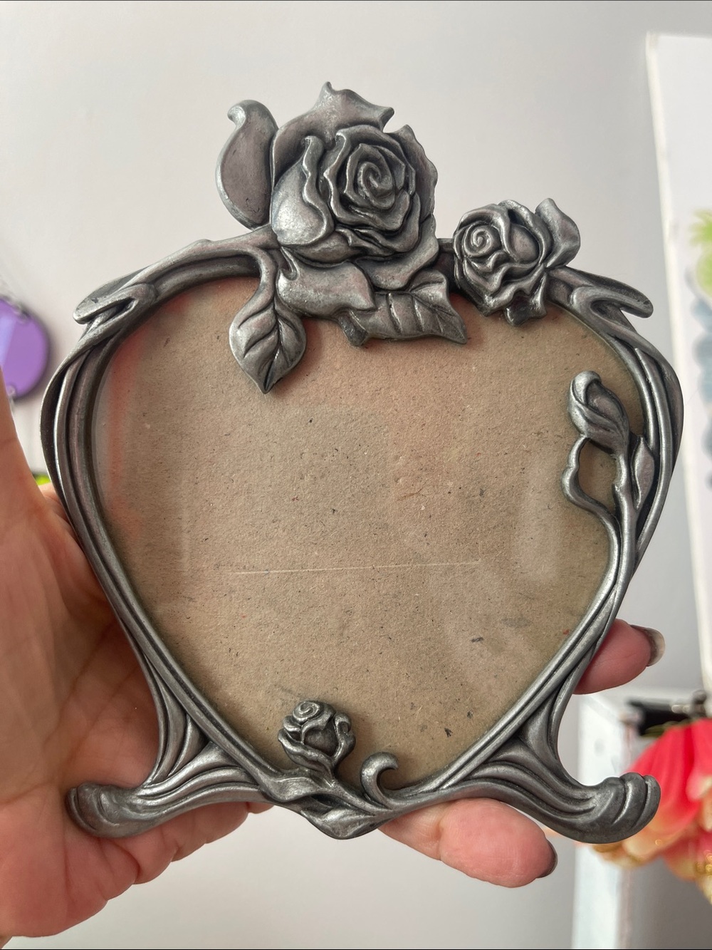 Pewter-like heart-shaped photo frame in decorative rose motif